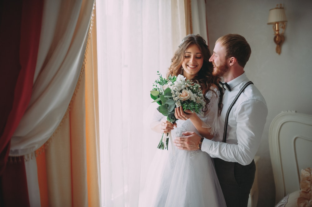 A stylish couple in a historic setting for their wedding - important considerations to make when finding wedding venues for sale